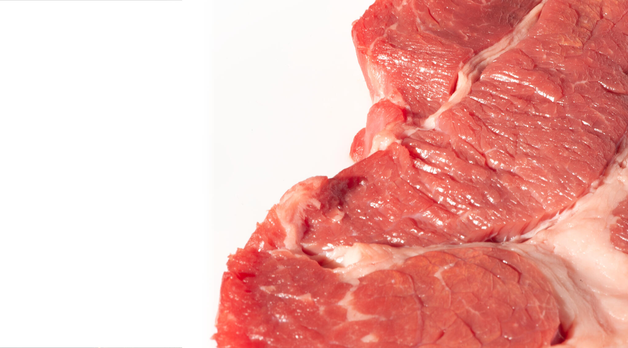 the full right side of the frame is taken up by a close-up of a raw steak