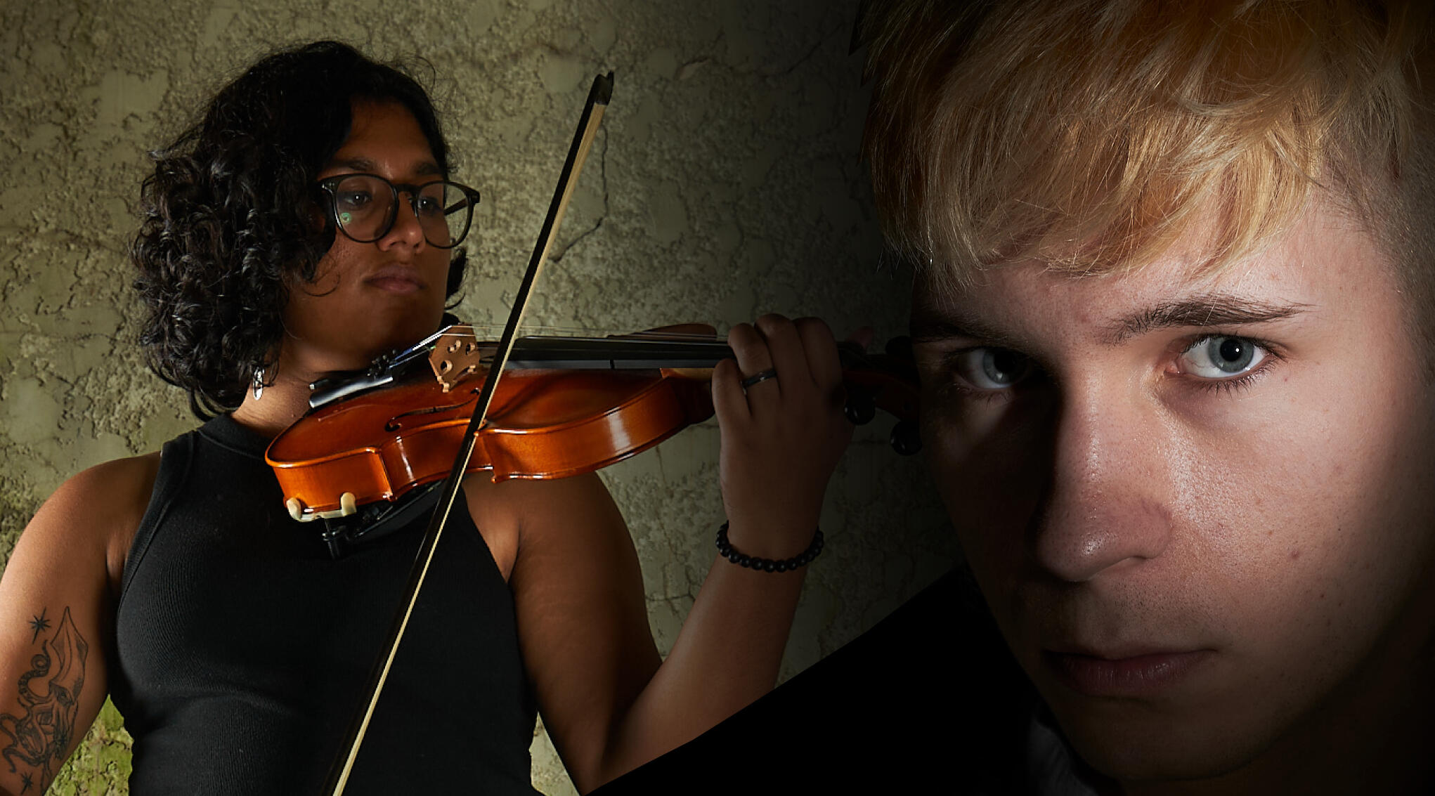 On the left a violinist is playing her violin in front of a stony background and on the right of the image a photo of a man looking seriously into the camera amongst a black background