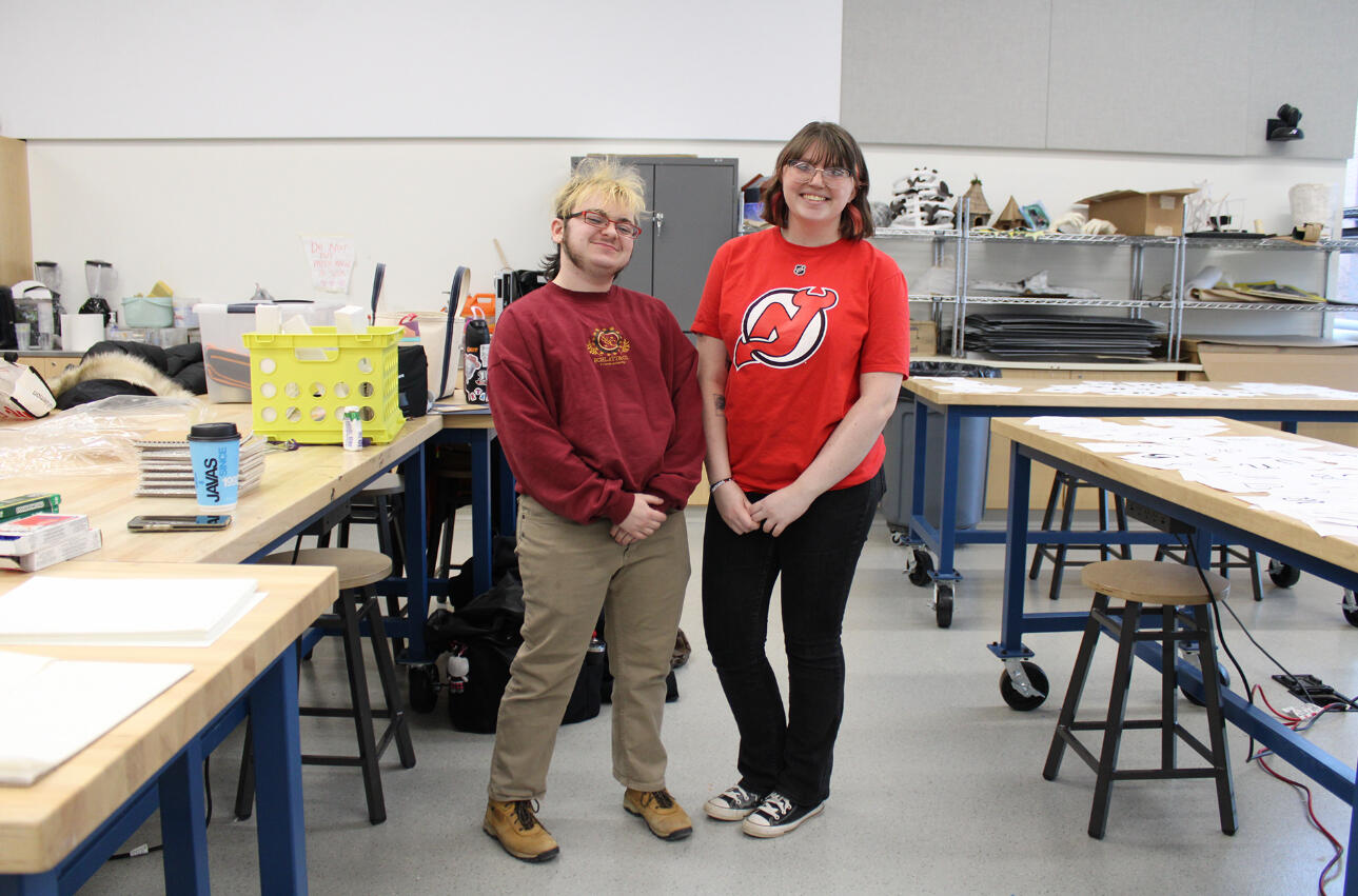 Photo of Lyle O. Lewis and Liz Carro standing next to each other in an art classroom